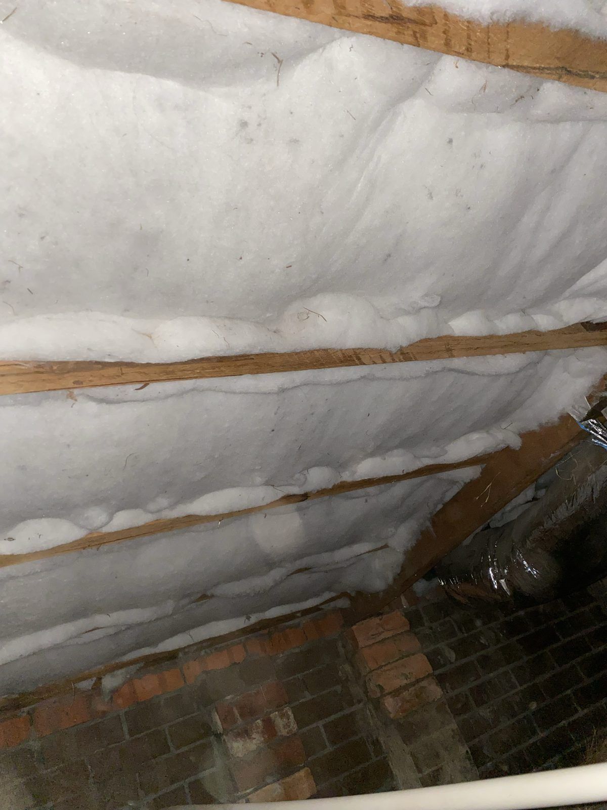 Polyester underfloor insulation batts fitted under a timber floor in Melbourne