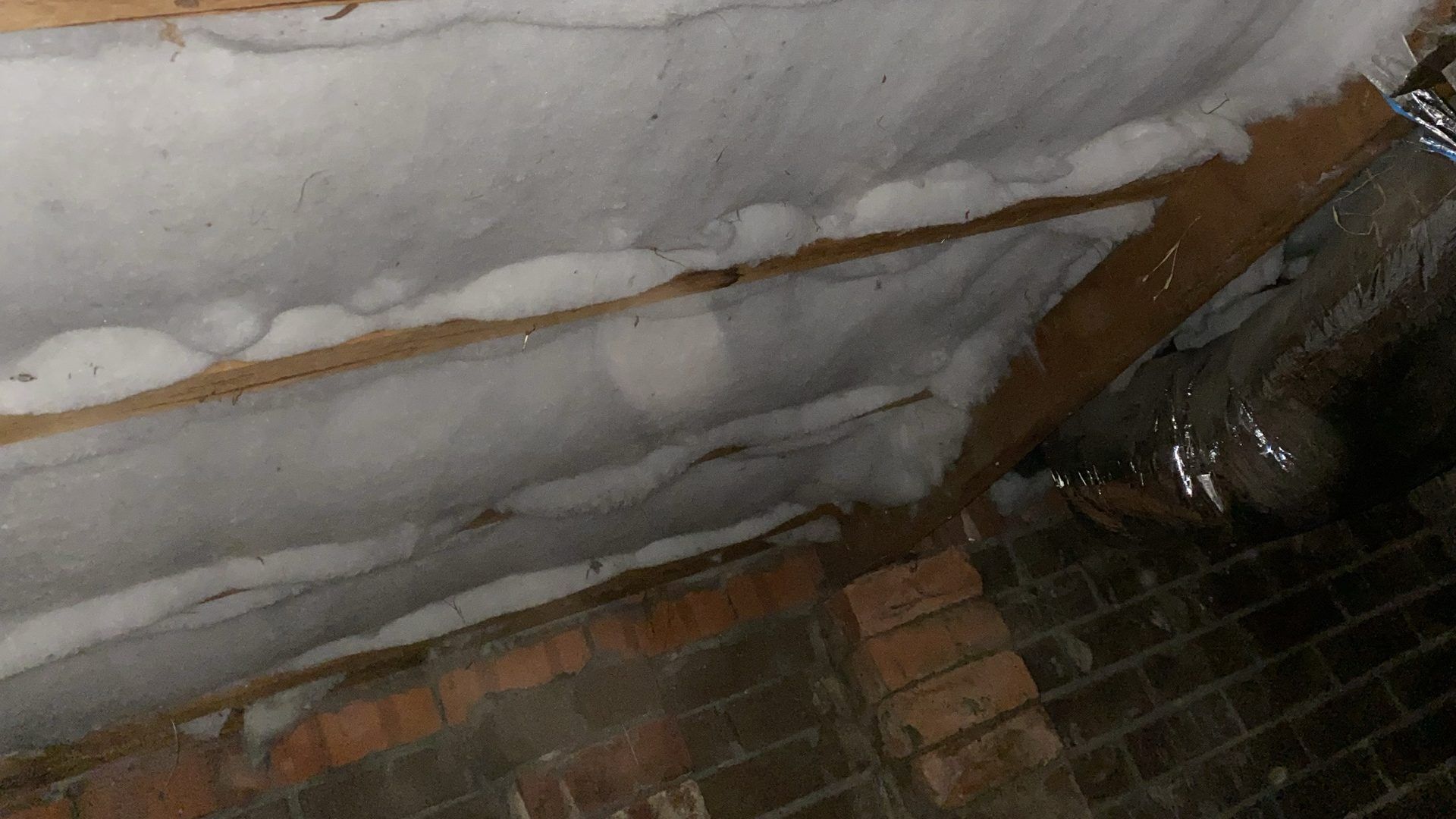 Polyester underfloor insulation batts fitted between floor joists in Melbourne
