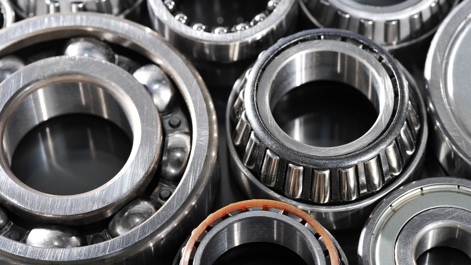 Close-up of various ball bearings, silver metal, arranged together.