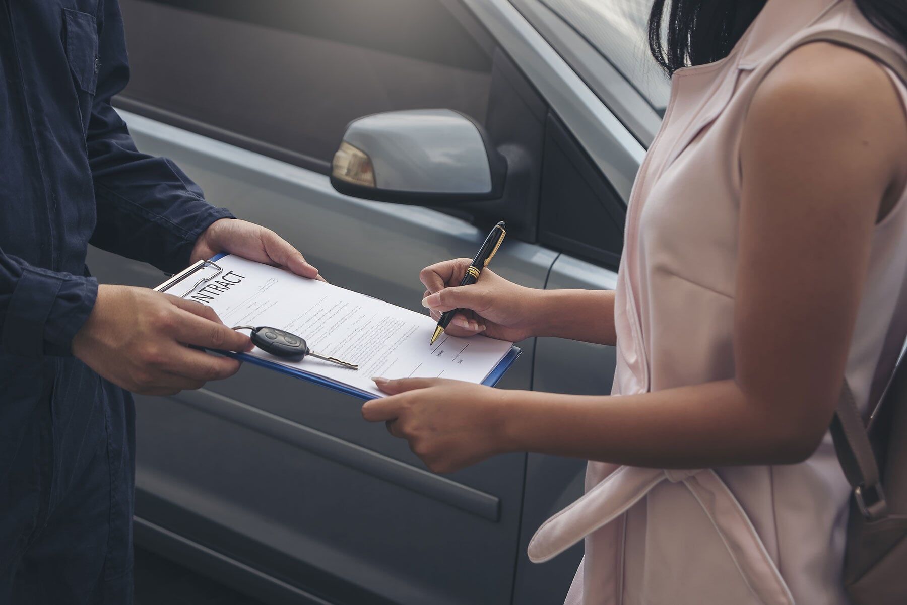 Mechanic With a Customer Signing Paperwork — Car Restoration in Taree, NSW