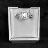 Diamond ring in a white jewelry box on a dark background