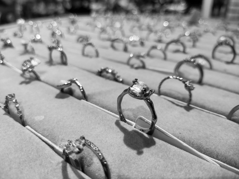 Rows of rings displayed on padded trays in a jewelry showcase