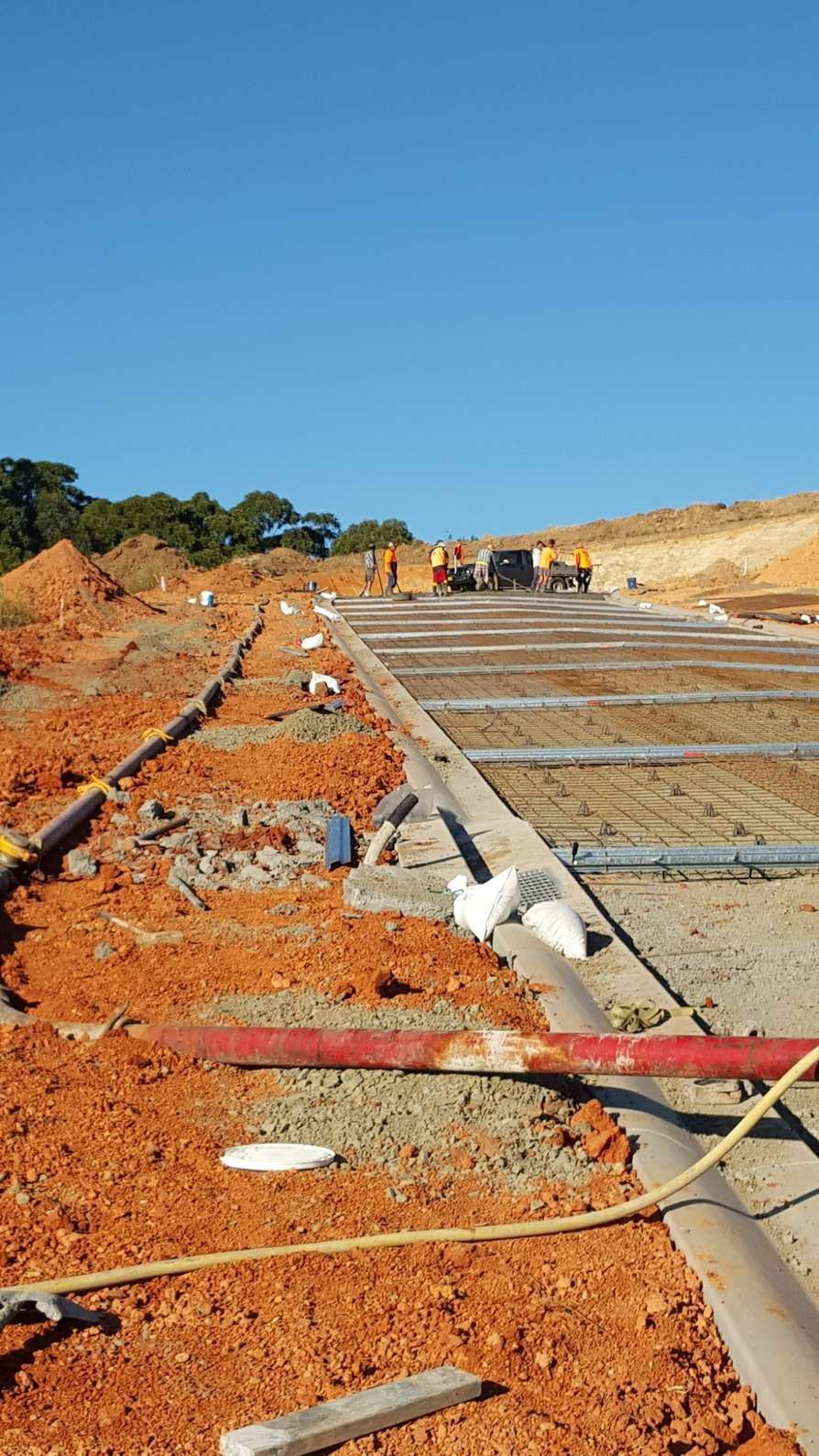 A Construction Site With a Lot of Dirt and Pipes Laying on the Ground — Felto's Concrete Line Pumping in Corindi Beach, NSW