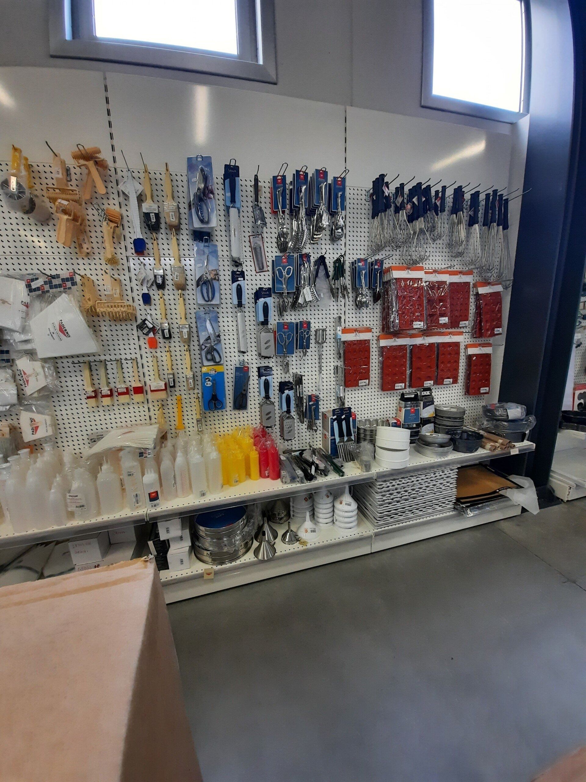 Conservare sotto le finestre un espositore a parete con attrezzi e accessori assortiti in confezioni di plastica trasparente.