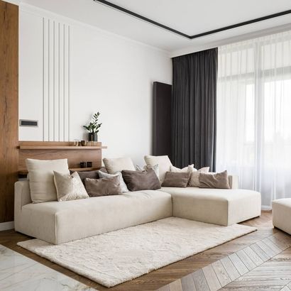 A living room with a large couch and a rug — Windemere, FL — Valor Homes Construction LLC A living room with a large couch and a rug — Windemere, FL — Valor Homes Construction LLC