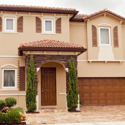 A house with a brown door and a stone walkway — Windemere, FL — Valor Homes Construction LLC A house with a brown door and a stone walkway — Windemere, FL — Valor Homes Construction LLC
