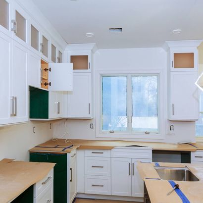 A kitchen with white cabinets and a window — Windemere, FL — Valor Homes Construction LLC A kitchen with white cabinets and a window — Windemere, FL — Valor Homes Construction LLC