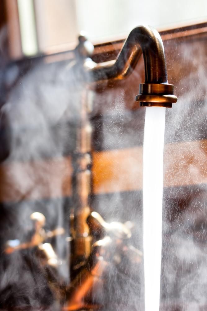 Steamy Water Pouring From a Brass Faucet — David McNeill Plumma (Gas Specialist) In Cessnock, NSW