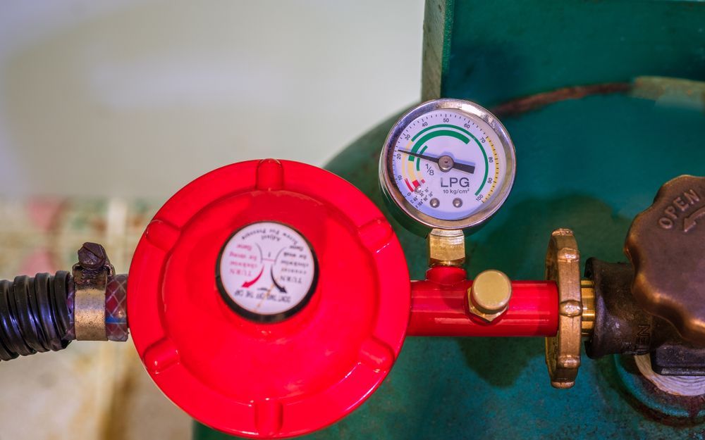 Red LPG Regulator With Gauge on a Green Gas Cylinder — David McNeill Plumma (Gas Specialist) In Cessnock, NSW