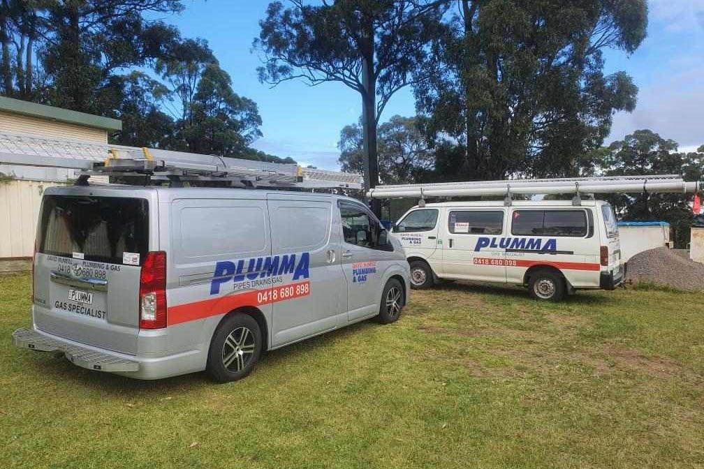 Two vans parked on a lawn with brand logo on them — David McNeill Plumma (Gas Specialist) In Cessnock, NSW