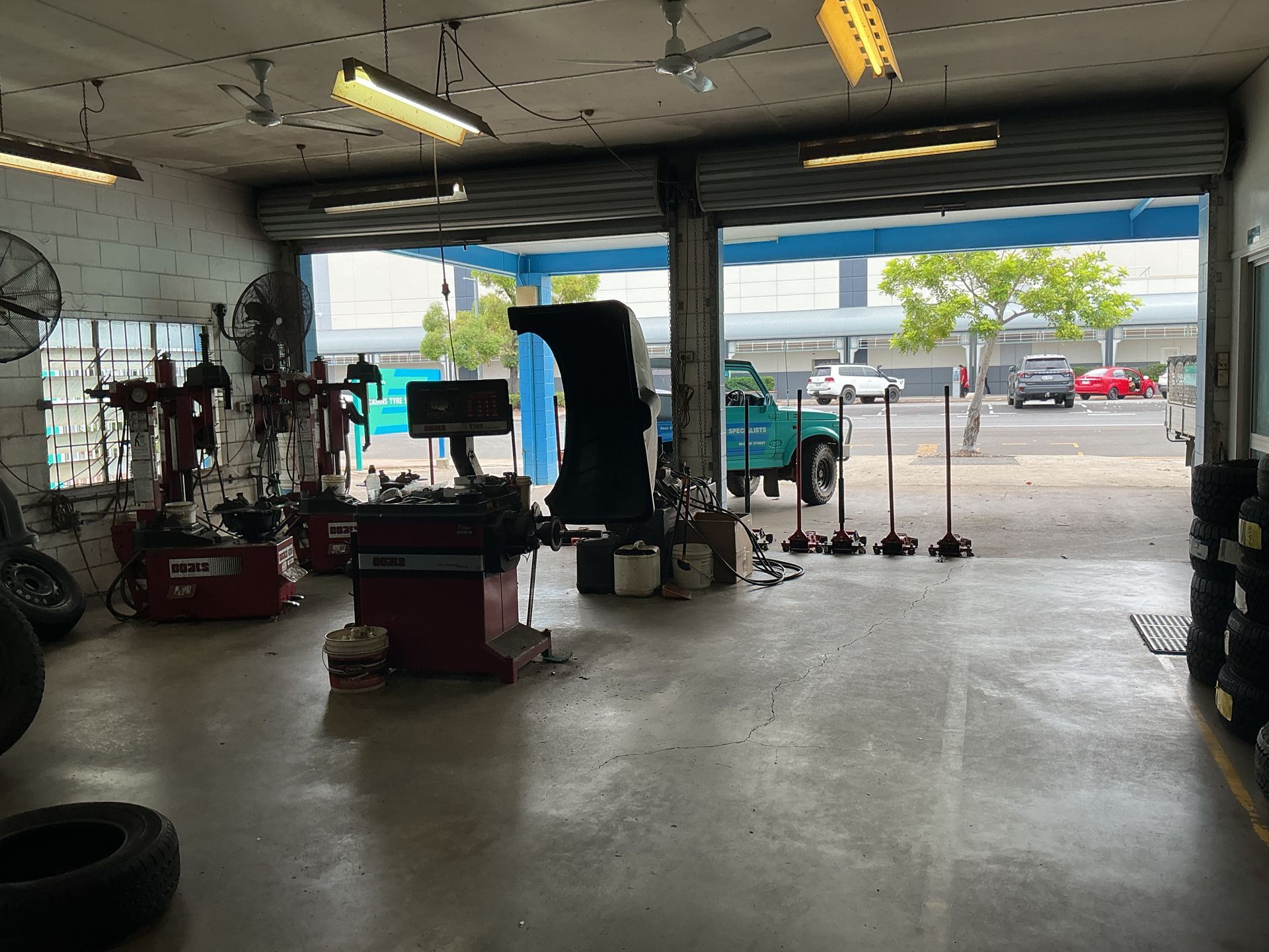 Inside of a Tire Shop With Open Garage Door — Cairns Tyre Specialists In Cairns City, QLD