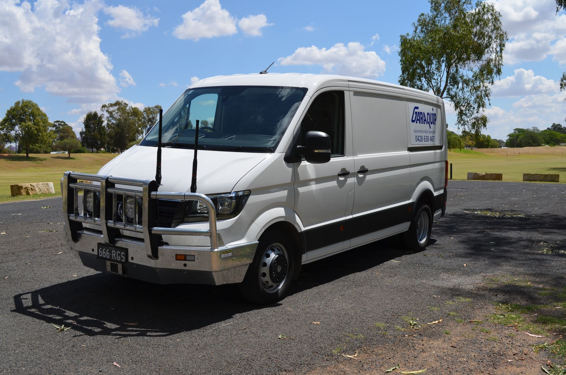 Garaquip Van Parked on Road Having Garaquip Logo On It — Vehicle Hoist Near Dubbo