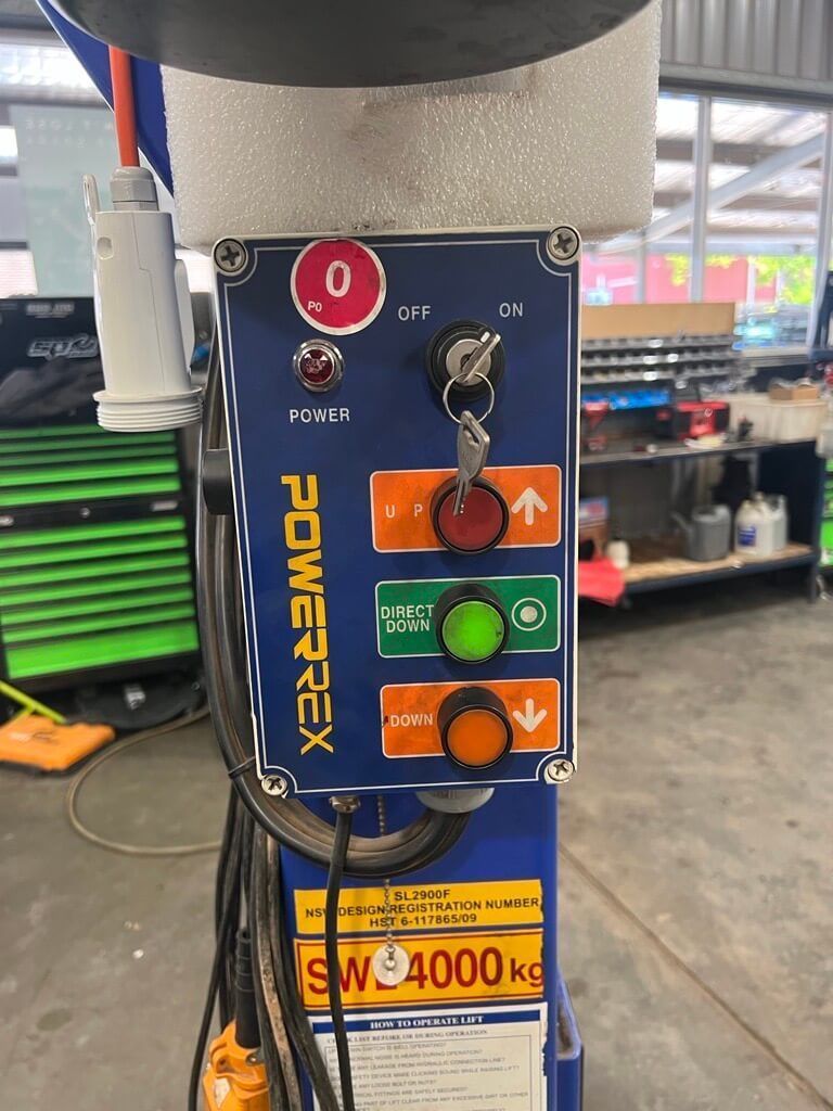 A Hoist Control Panel With Red, Green And Orange Button On It — Hoist in Parkes