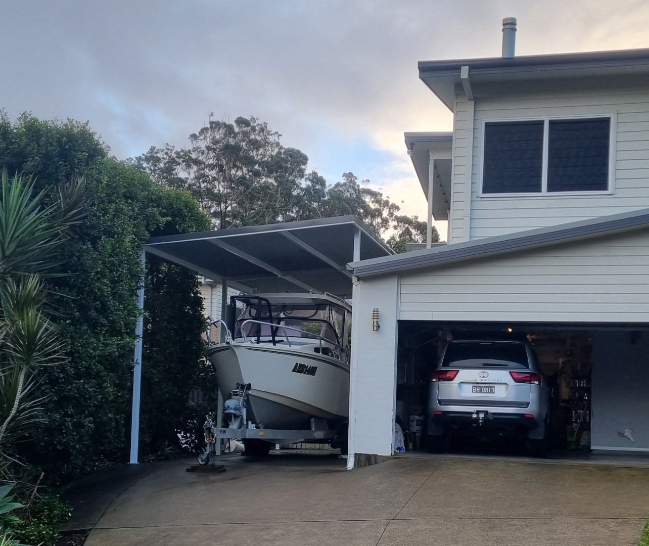House with A Boat Parked Under a Carport — Fair Dinkum Builds Port Stephens in Bobs Farm, NSW