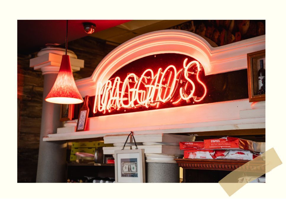 A bright red neon sign reads