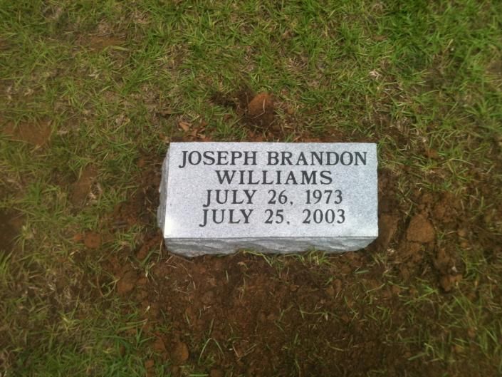 Gravestone for Joseph Brandon Williams in grass, marked July 26, 1973 and July 25, 2003