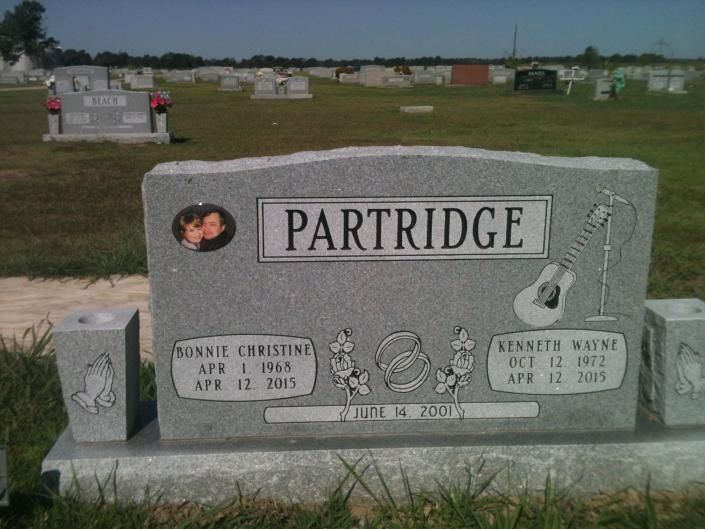 Partridge family gravestone in a cemetery with a small portrait photo and engraved name panels.