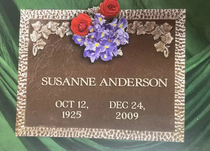 Gravestone for Susanne Anderson with red and purple flowers, dated Oct. 12, 1925 to Dec. 24, 2009