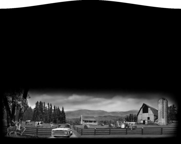 Black-and-white rural farmyard with barns, silo, fences, trees, and distant mountains under a cloudy sky