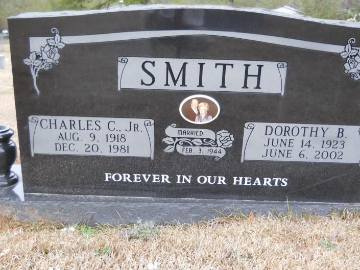 Black granite Smith family gravestone with engraved names and dates in a cemetery