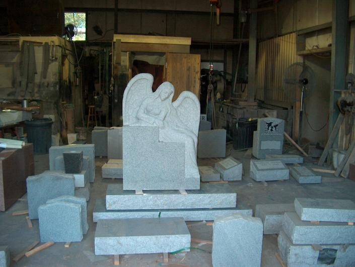 Stone sculpture workshop with unfinished carvings and blocks scattered on the floor