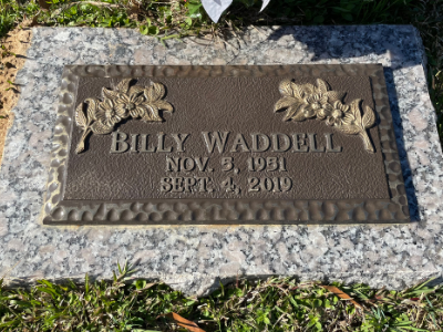 Gravestone with floral carvings reading “Billy Waddell, Nov. 4, 1951 – Sept. 2, 2010”