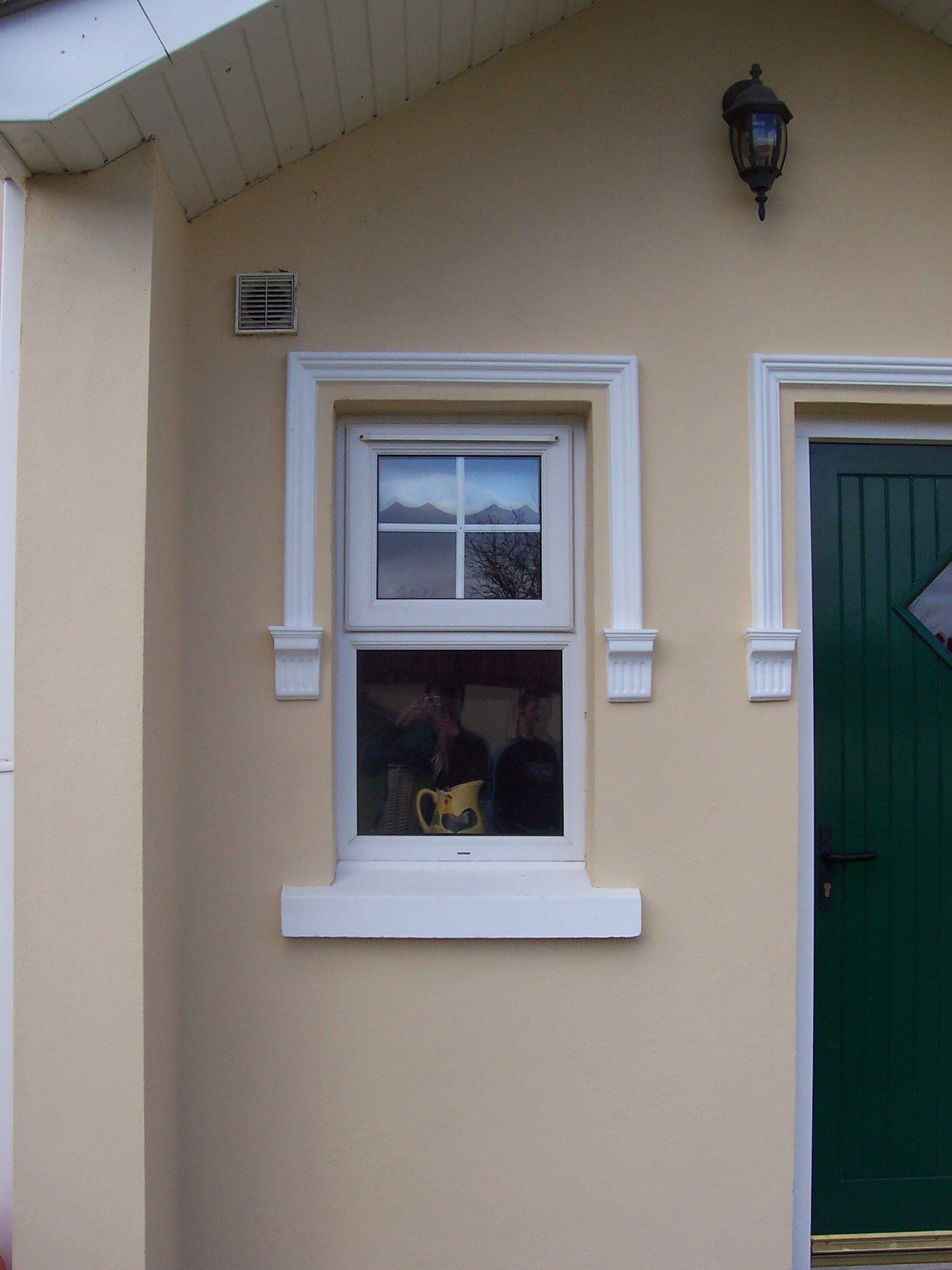 A house with a green door and a window