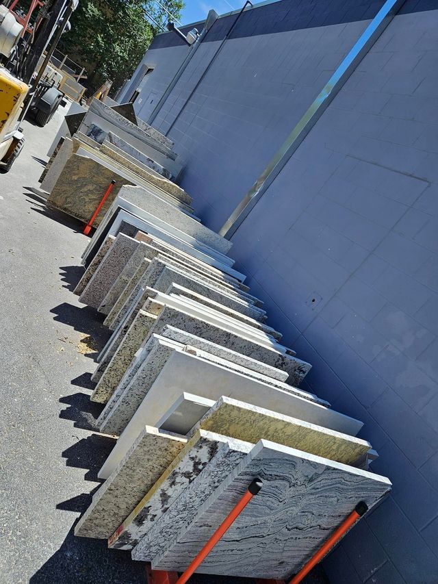 A bunch of marble slabs are stacked on top of each other on a cart.