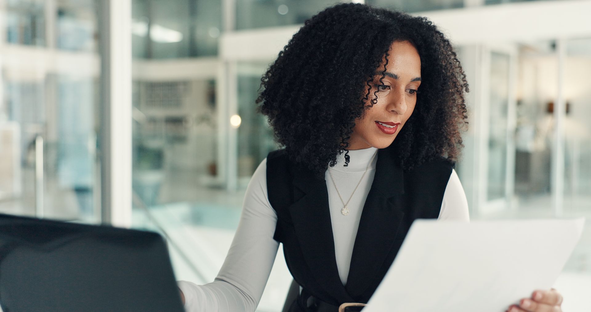 Payroll professional reviewing financial documents in a modern office