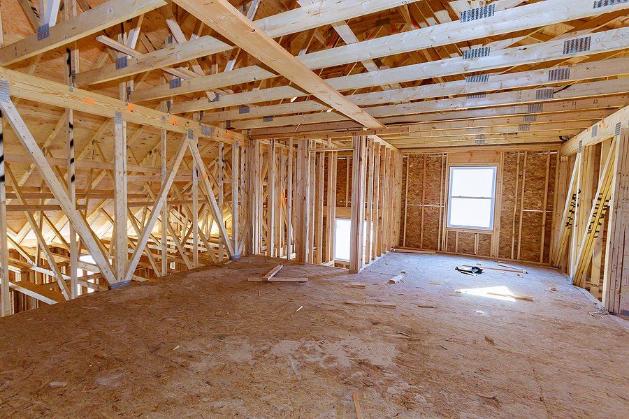 Bathroom Remodeling Services in Albany County, WY Unfinished wooden room framing with exposed beams, studs, and a single window letting in daylight