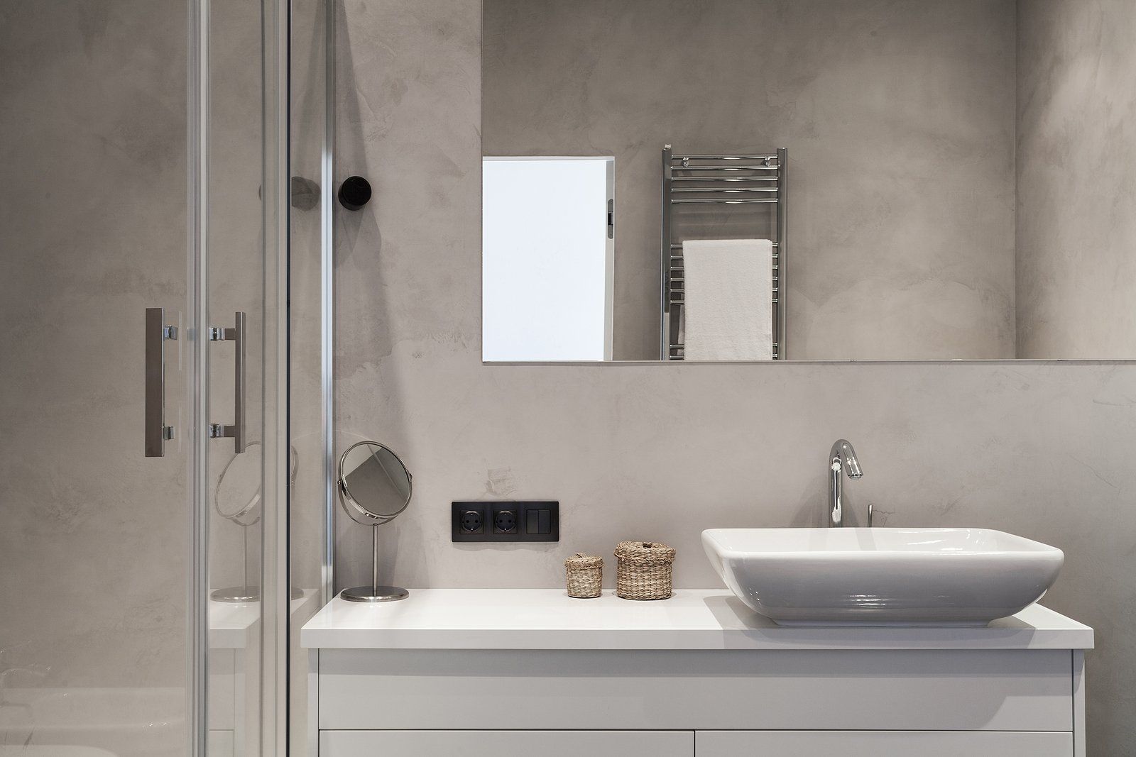 Bathroom Remodeling Services in Albany County, WY Modern gray bathroom with glass shower, white vanity, sink, mirror, and towel rack