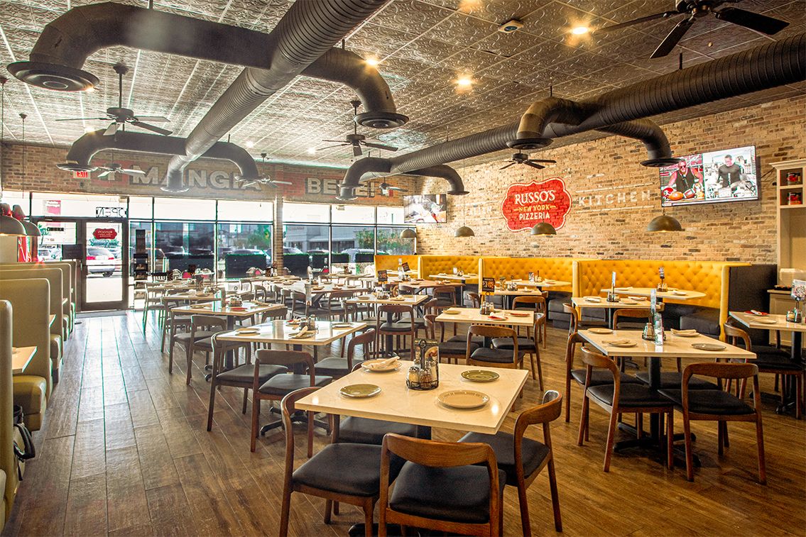 Restaurant interior with tables, chairs, and booths.