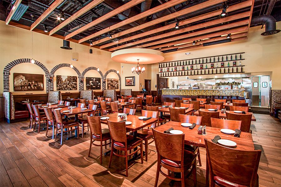 Interior of a restaurant with wooden tables and chairs.