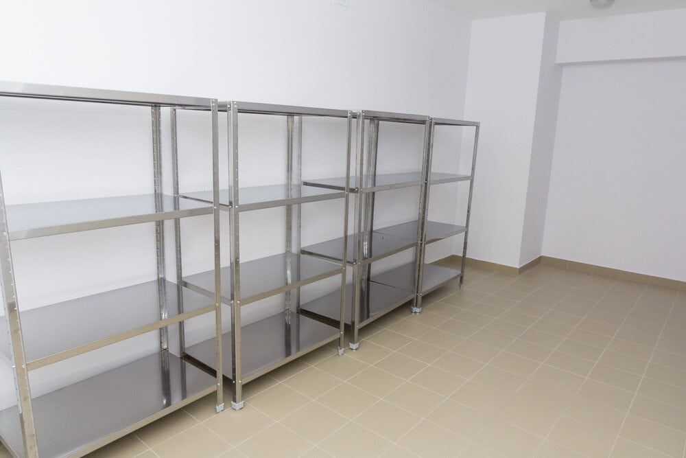 Stainless Steel Shelving Units Against a White Wall in a Room — Townsville Stainless Steel in Gold Coast, QLD