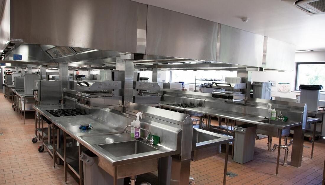 A Large Kitchen with Lots of Stainless Steel Appliances and Sinks — Townsville Stainless Steel in Garbutt, QLD