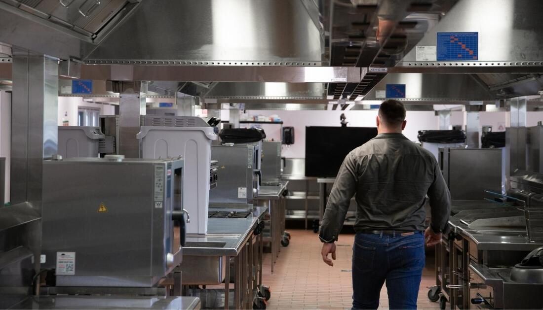 Man Walking Inside Commercial Kitchen — Townsville Stainless Steel in Garbutt, QLD