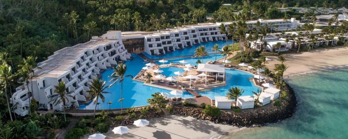 An Aerial View of A Hotel Surrounded by Palm Trees and Umbrellas — Townsville Stainless Steel in Garbutt, QLD