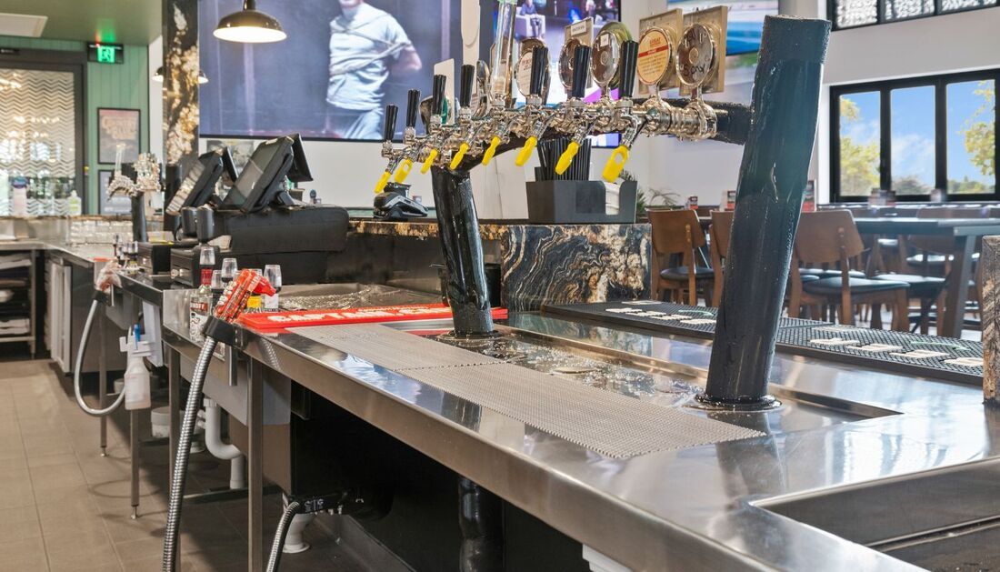 A Long Stainless Steel Bar in A Restaurant with A Lot of Beer Taps — Townsville Stainless Steel in Mount Isa, QLD