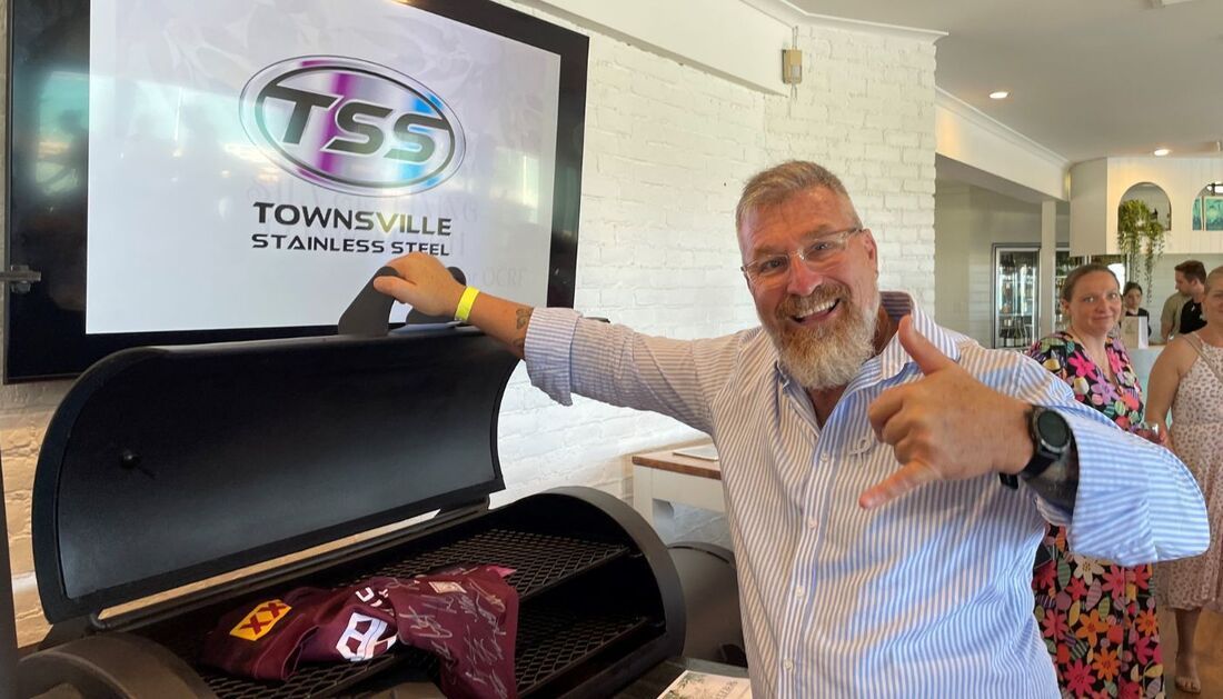 A Man Is Standing in Front of A Grill and Giving a Thumbs Up — Townsville Stainless Steel in Garbutt, QLD A Man Is Standing in Front of A Grill and Giving a Thumbs Up — Townsville Stainless Steel in Garbutt, QLD