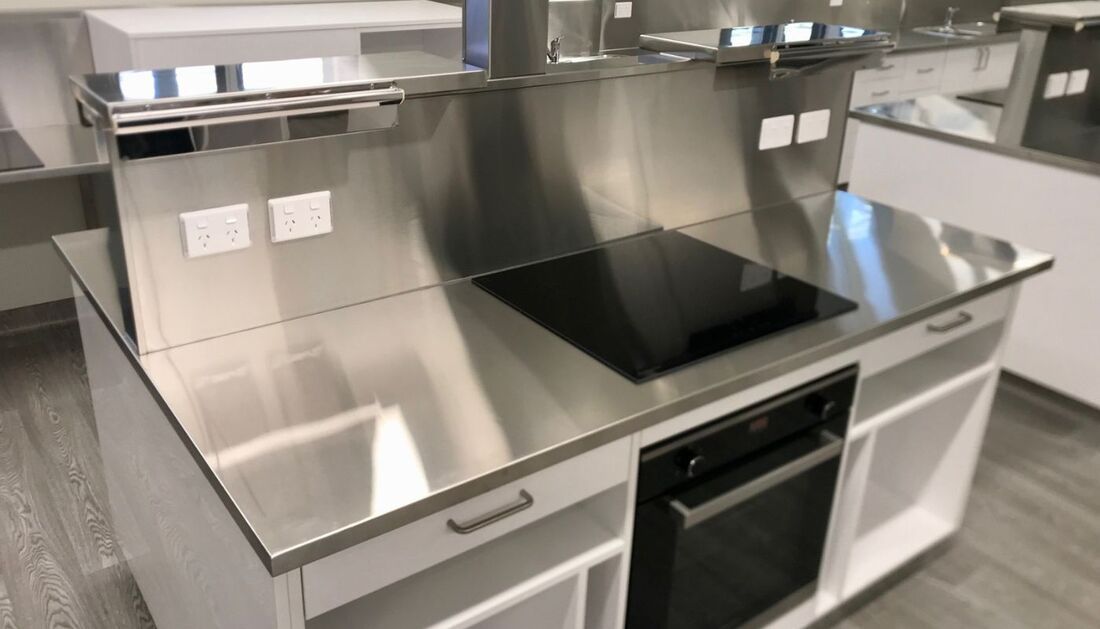 A Kitchen with A Stainless Steel Counter Top and A Stove Top Oven — Townsville Stainless Steel in Garbutt, QLD A Kitchen with A Stainless Steel Counter Top and A Stove Top Oven — Townsville Stainless Steel in Garbutt, QLD