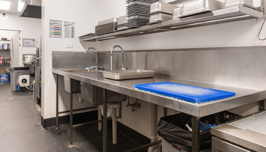 A Kitchen with A Sink and A Cutting Board on The Counter — Townsville Stainless Steel in Rockhampton, QLD