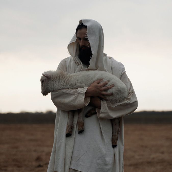 shepherd holding a sheep