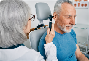 ENT doctor looking at the patient's ear
