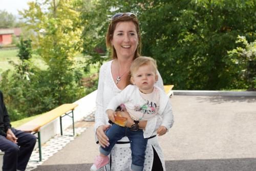 Eine Frau sitzt auf einem Stuhl und hält ein Baby.