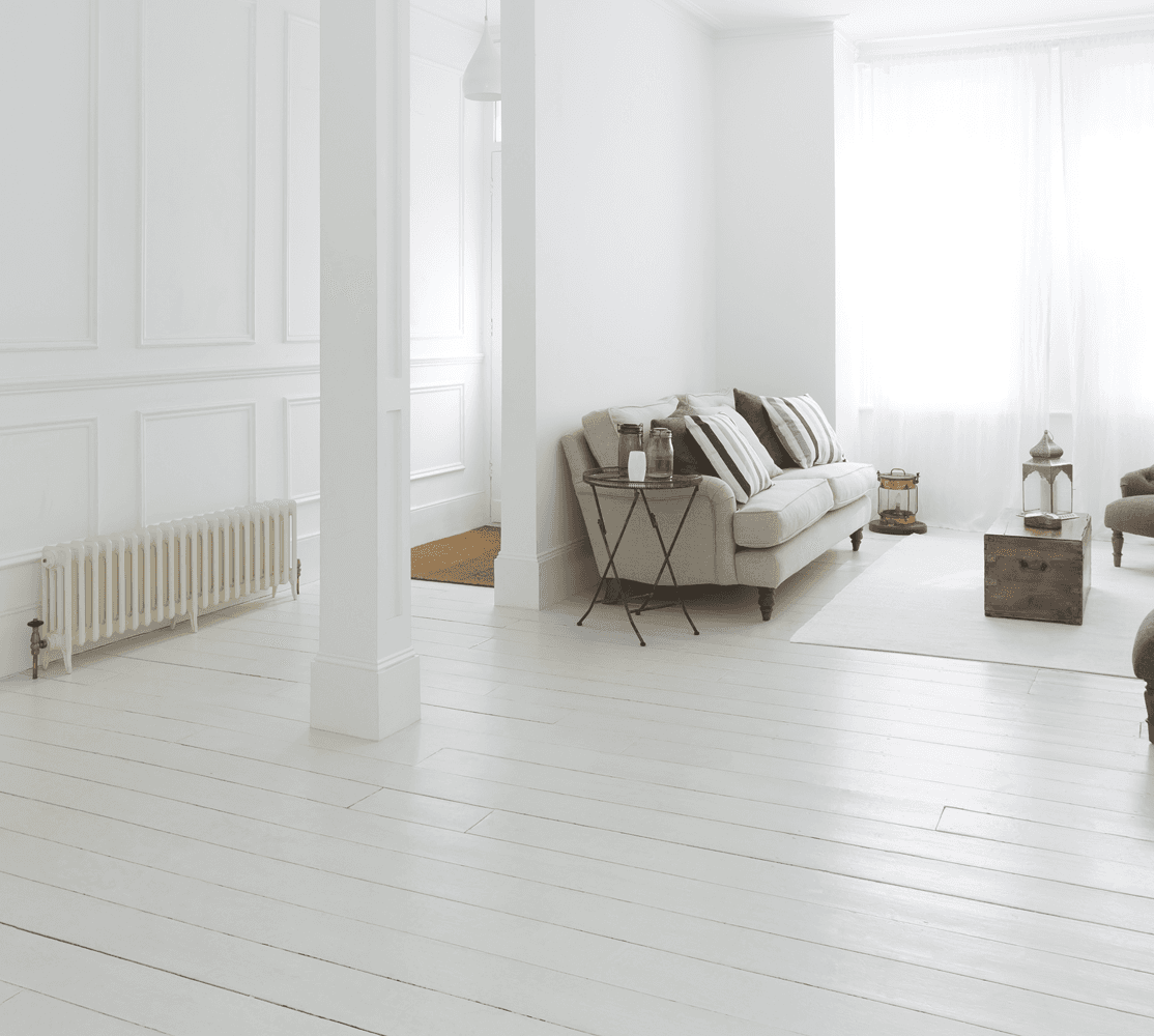 A white living room with a couch and chairs