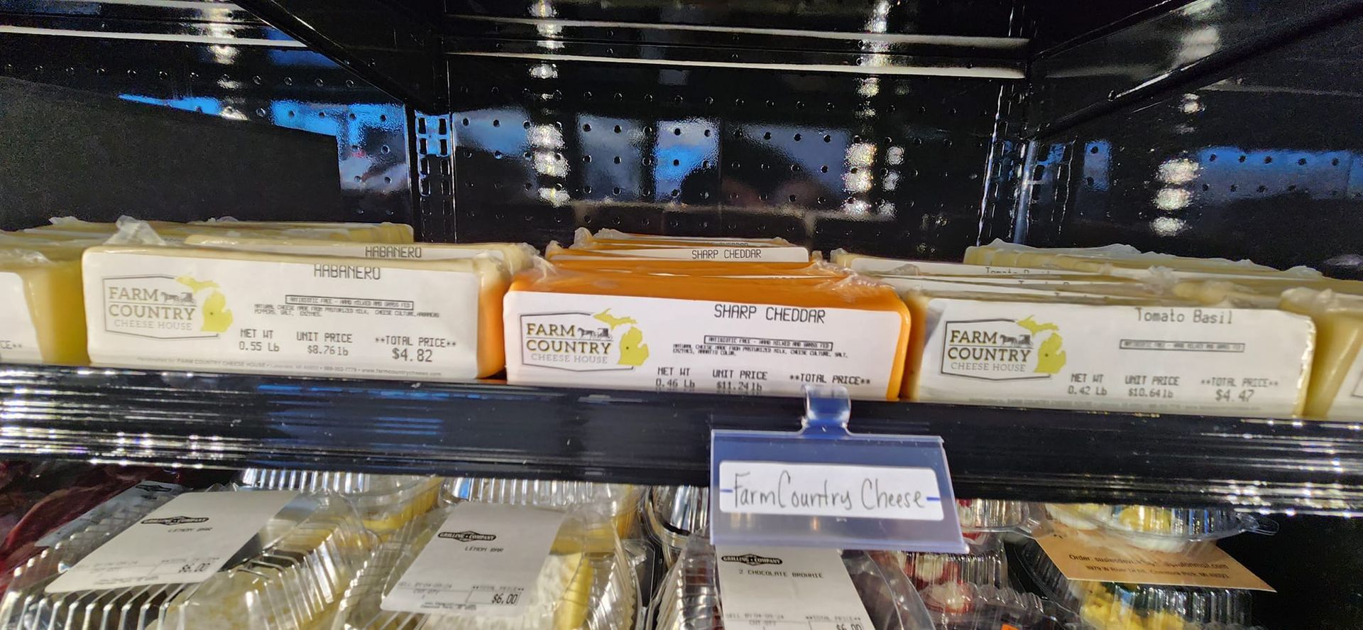 A refrigerator filled with different types of cheese