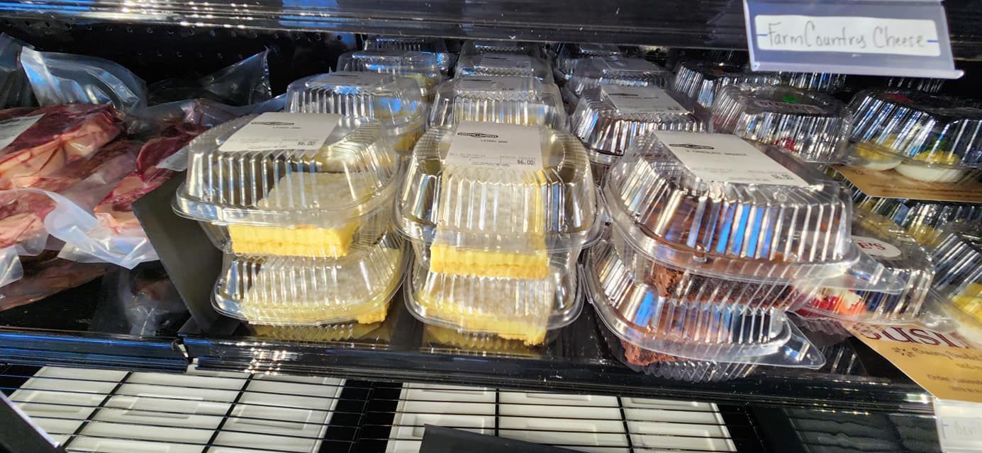 A display case filled with plastic containers of food.