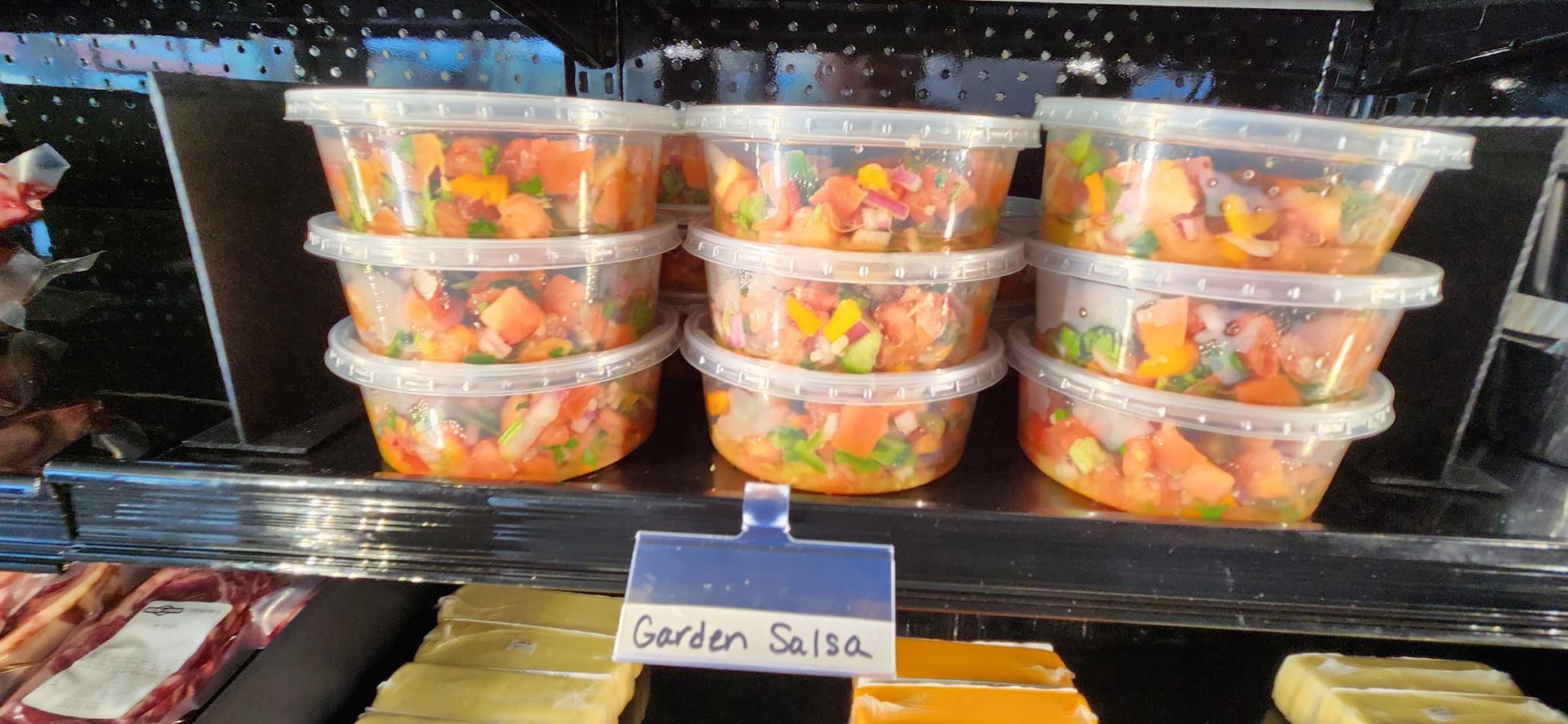 A display case with a sign that says garden salsa