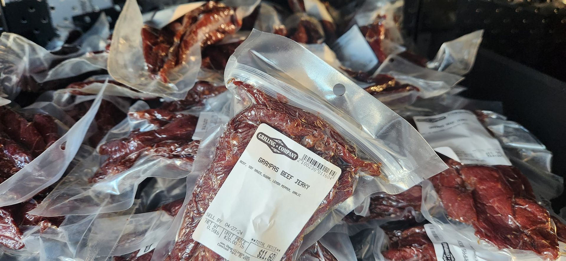 A bag of jerky is sitting on top of a pile of jerky.