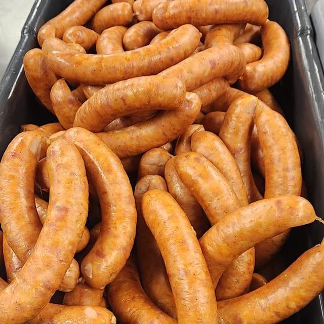 A pile of sausages in a black container